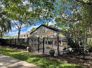 Guests can enjoy a peaceful outdoor space at The Grove, surrounded by lush greenery and trees.