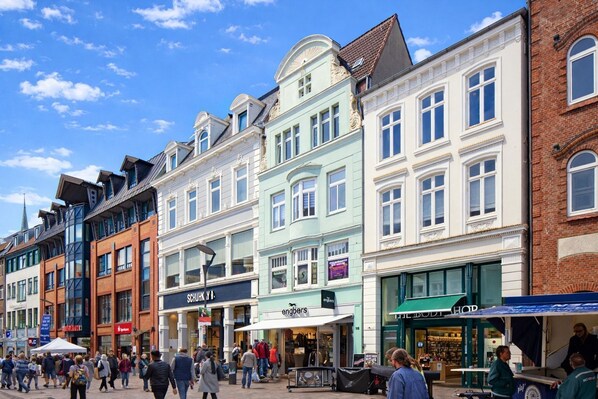 A street with various shops and a pedestrian area.