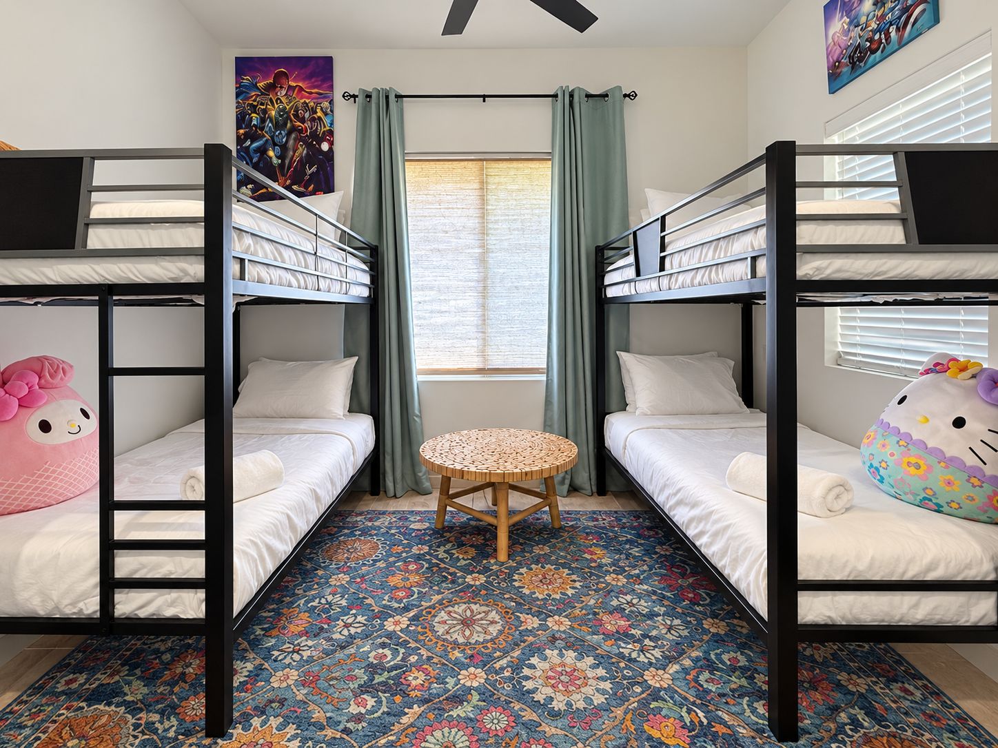 A room with two bunk beds, a round table, and a patterned floor.
