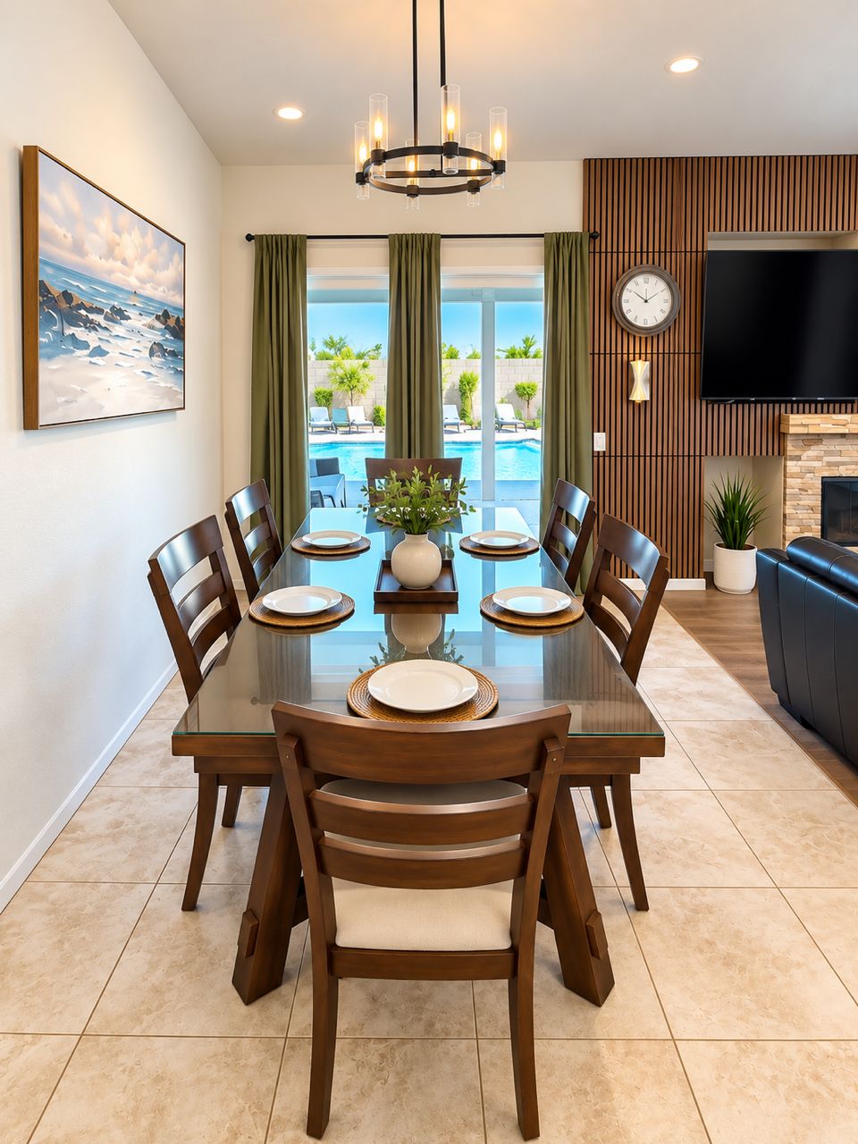 A dining area with a glass table, wooden chairs, and a view of a swimming pool.