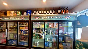 A refrigerated display case with various beers and alcoholic beverages.