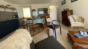 A compact living space with a dining area, kitchen, and seating area.