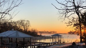 A gazebo and a covered area by a lake during sunset. - Lake Fork house with private boat ramp, dock, fishing light, kayak, 8 acres land (Alba)
