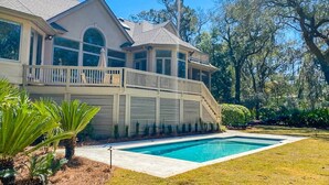 A large house with a swimming pool, a covered patio, and a well-maintained lawn. - 4 Minute Walk to Beach!  Private Pool With Pool Heater.*  Back Deck w/ Lagoon & Golf Course Views! (Hilton Head Island)
