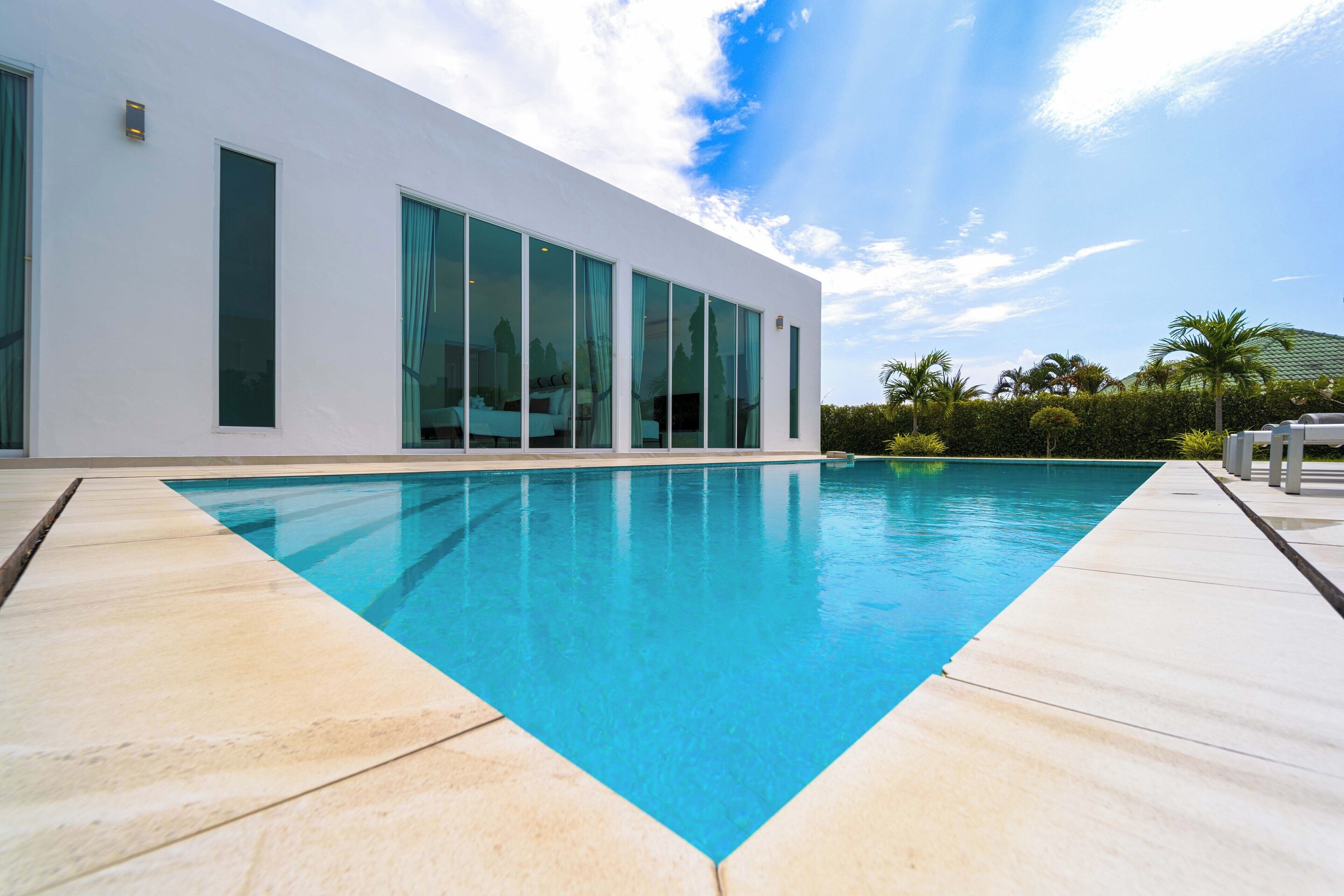 A modern building with large windows and a swimming pool.