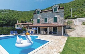 A stone villa with a swimming pool, outdoor seating, and a scenic hillside view. - Quiet Village Villa (Desne)