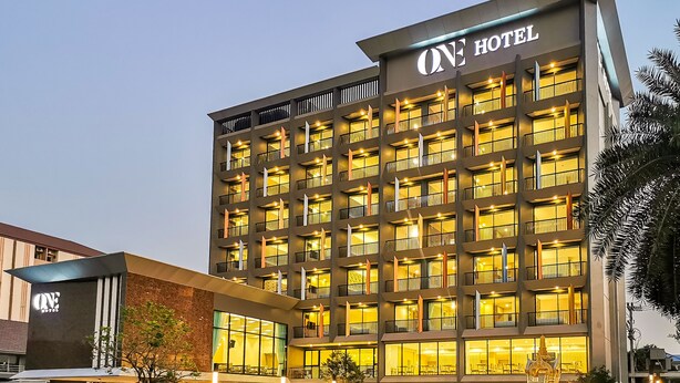 A multi-story hotel with a modern facade, large windows, and a prominent 'ONE HOTEL' sign. - ONE Hotel (Khlong Luang)