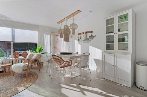 Stylish vacation home with bright furnishings and garden and terrace and porch.