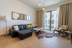 Deluxe Apartment | Living area | 55-inch Smart TV with cable channels, TV, Netflix - HiGuests - La Cote B2 (Dubai)