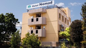 A building with a sign reading "Hotel Nomad." It has multiple balconies and appears to be a multi-story hotel. - Hotel Nomad Hitachi (Hitachi)