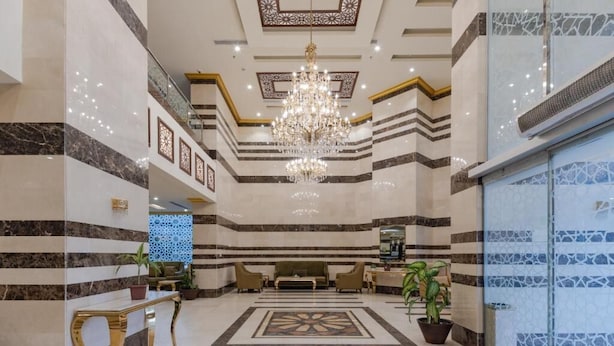 A lobby with a chandelier, a reception desk, and a patterned floor. - Snood AL-Dana Hotel (Makkah)