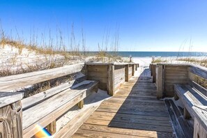 A wooden boardwalk leading to a sandy beach with dunes and sparse vegetation. - Palm Beach D44, Beachfront, Pool, Private Balcony-Sea South Properties (Orange Beach)