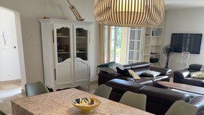 A dining area with a rectangular table, six chairs, and a decorative bowl on the table. - Magnificent villa in the heart of the Var for a superb vacation. (La Verdiere)