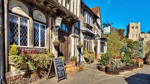 A traditional pub with a signboard advertising food and drink. - The WoolPack Inn (Colchester)
