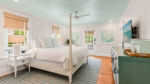 A bedroom with a bed, bedside table, nightstand, and a green cabinet. - HONEY~ Adult Only, 2nd Floor 1 King Bedroom Unit w/ Community Pool! (Key West)