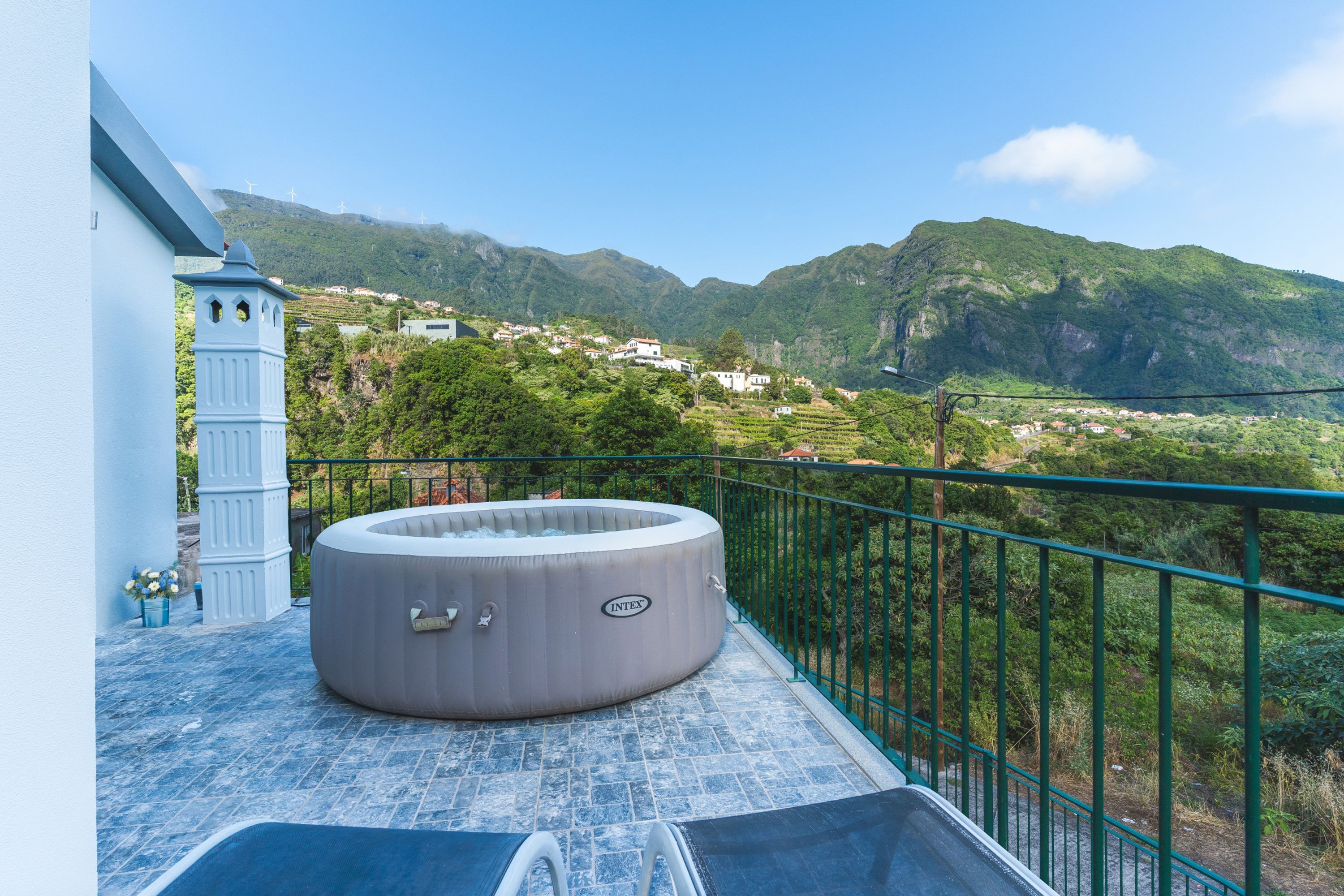 A hot tub on a balcony with a mountain view.