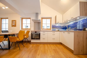 Enjoy cooking in this well-equipped kitchen with a central island, sink, and stove.