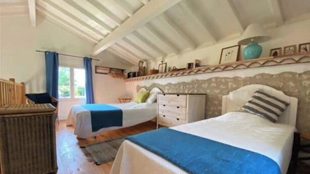 A bedroom with two beds, a dresser, a chair, and a window with curtains. - 1 Bedroom Private vacation home in Ronsenac (Ronsenac)
