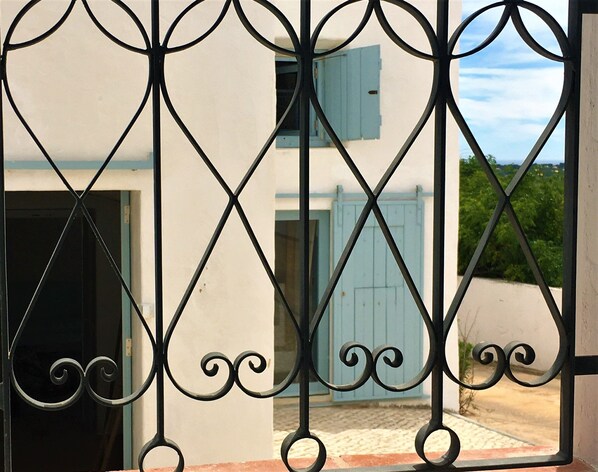A metal gate with decorative scrollwork.