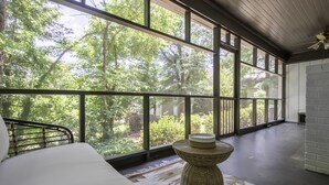 A bedroom with a large window, a bed, a woven side table, and a rug. - 3,700 sqft-Cozy/Private Villa style Ranch in SouthPark-King en Suite-Winter Rdy! (Charlotte)