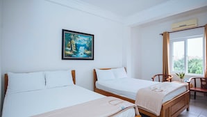 A hotel room with two single beds, a painting of a landscape, a window with curtains, and a chair. - Chapi Hotel (Dong Hoi)