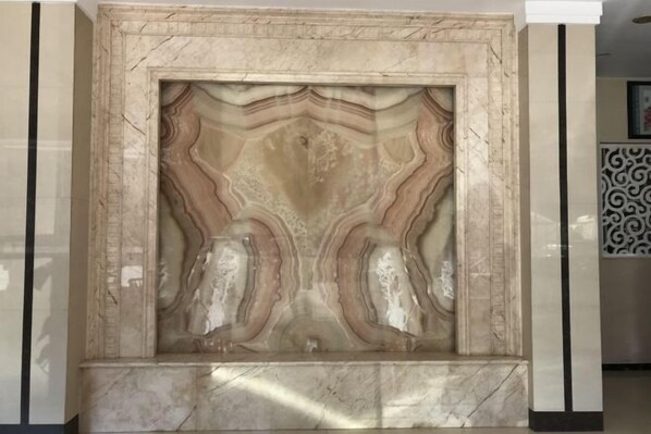 A marble wall with a unique, wavy pattern. - Hezhou Xintai Hotel (Hezhou)