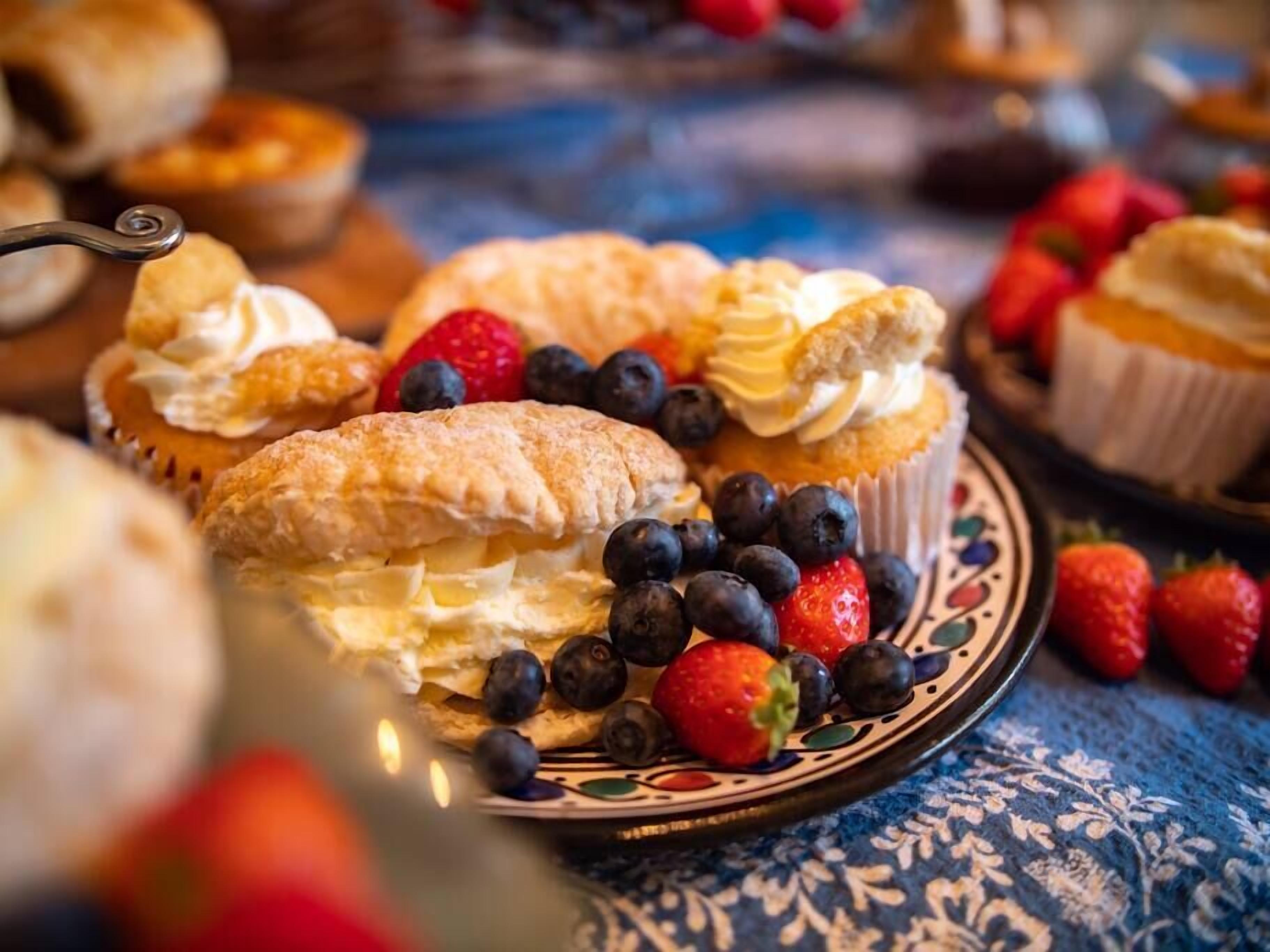A variety of pastries and fruits on a table.