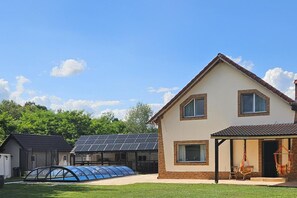 A house with a large garage, a covered patio, and a solar panel array. - Avrigelli, Kids&family Friendly (Avrig)