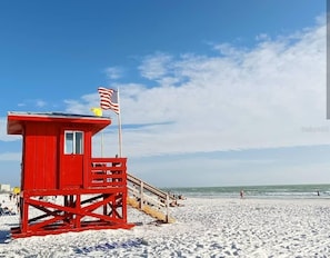 A red lifeguard tower with an American flag on a beach. - Bay View Condo, Minutes to Top Beach in the US (Siesta Key)
