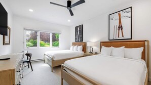 A modern hotel room with two beds, a desk, and a chair. - The Charter at Beaver Creek E135 (Beaver Creek)