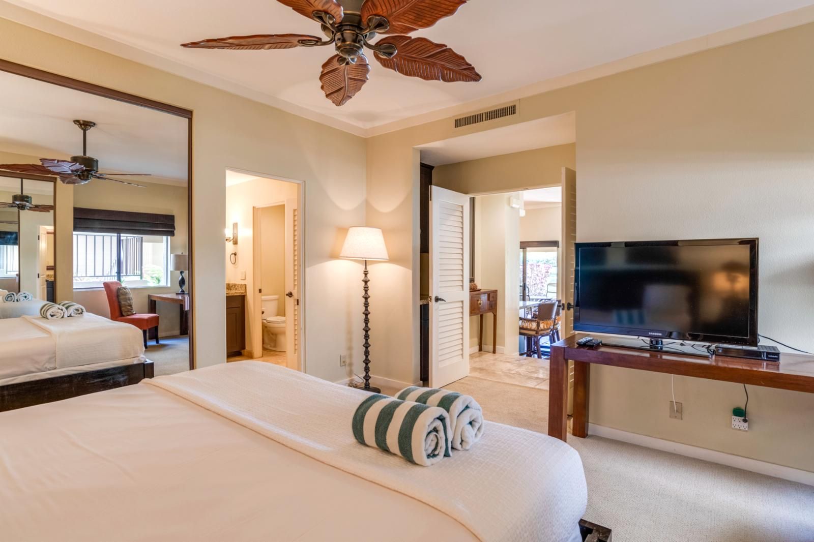 Let the island breeze and soft rustle of the fan lull you into serenity in this welcoming, well-appointed master room    