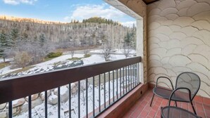 A balcony with a view of a snowy landscape and a forest. - The Charter at Beaver Creek B430 (Beaver Creek)