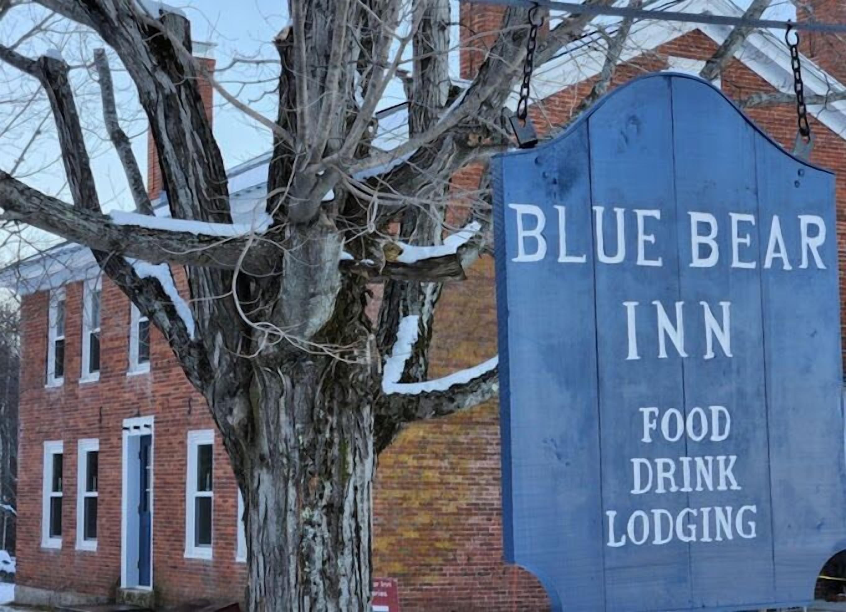 A sign for Blue Bear Inn, indicating it offers food, drink, and lodging services.