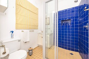 A bathroom with a toilet, sink, and shower area. - Amazing 2 Bedroom Apartment With Mountain Views on Kloof Street (Cape Town)