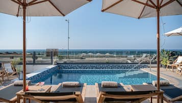 Seasonal outdoor pool, open 10:00 AM to 6:00 PM, pool umbrellas