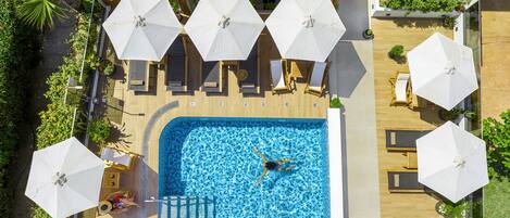 Seasonal outdoor pool, open 10:00 AM to 6:00 PM, pool umbrellas