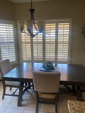 Enjoy meals in this dining area with a rectangular table and two comfortable chairs.