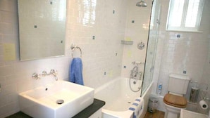 Ein Badezimmer mit Waschbecken, Badewanne, Dusche und Toilette.
