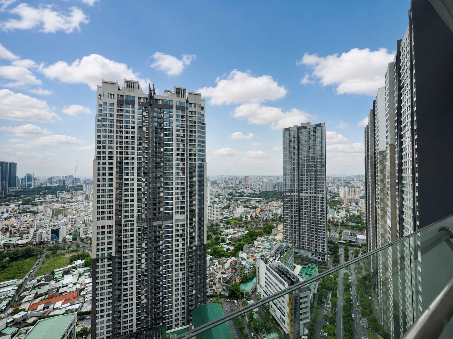 A high-rise building with multiple floors and a cityscape in the background.