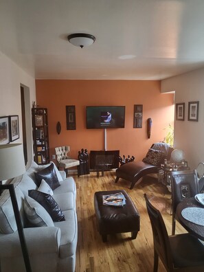 Relax in this stylish living room with a flat-screen TV, fireplace, and comfortable seating area.