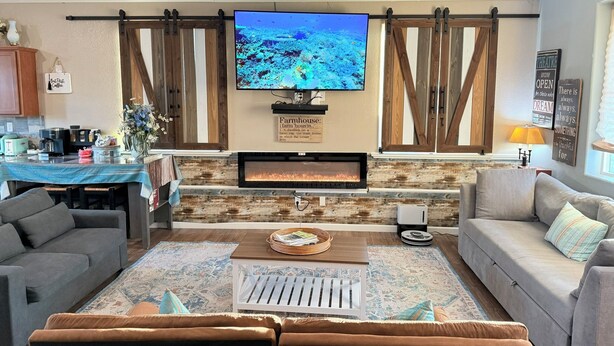 A living room with a fireplace, a television, and a sofa.