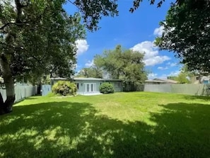 Enjoy a serene setting surrounded by lush trees and a well-manicured lawn.