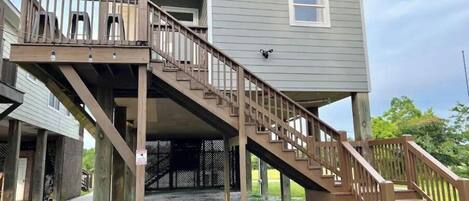 A two-story building with a wooden staircase leading to a balcony.