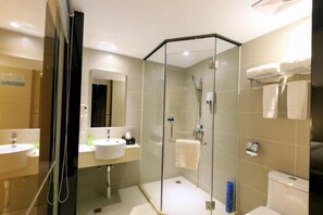 A modern bathroom with a glass-enclosed shower, two sinks, and a toilet. - Oriental Holiday Hotel (Beihai)