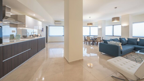 A modern apartment with a kitchen, dining area, and living room. - KYPSELI PLATINUM (Athens)