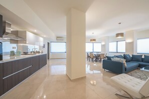 A modern apartment with a kitchen, dining area, and living room. - KYPSELI PLATINUM (Athens)