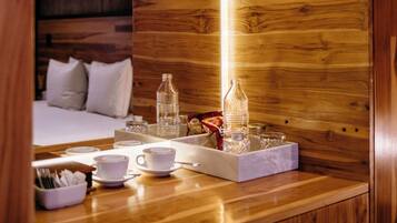 A wooden interior with a breakfast setup including cups, glasses, and a tray.