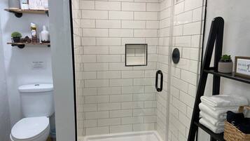 Shower, hair dryer, towels, toilet paper