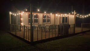 A covered outdoor area with string lights, a grill, and chairs. - Woodland Retreat I Pet Friendly I Mins to Town (Crivitz)
