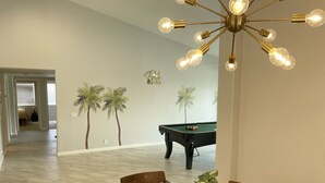 A dining area with a pool table, a chandelier, and a potted plant. - 3bed 2bath House.  Private Pool and Spa. Close to Acrisure Center  (Indian Wells)